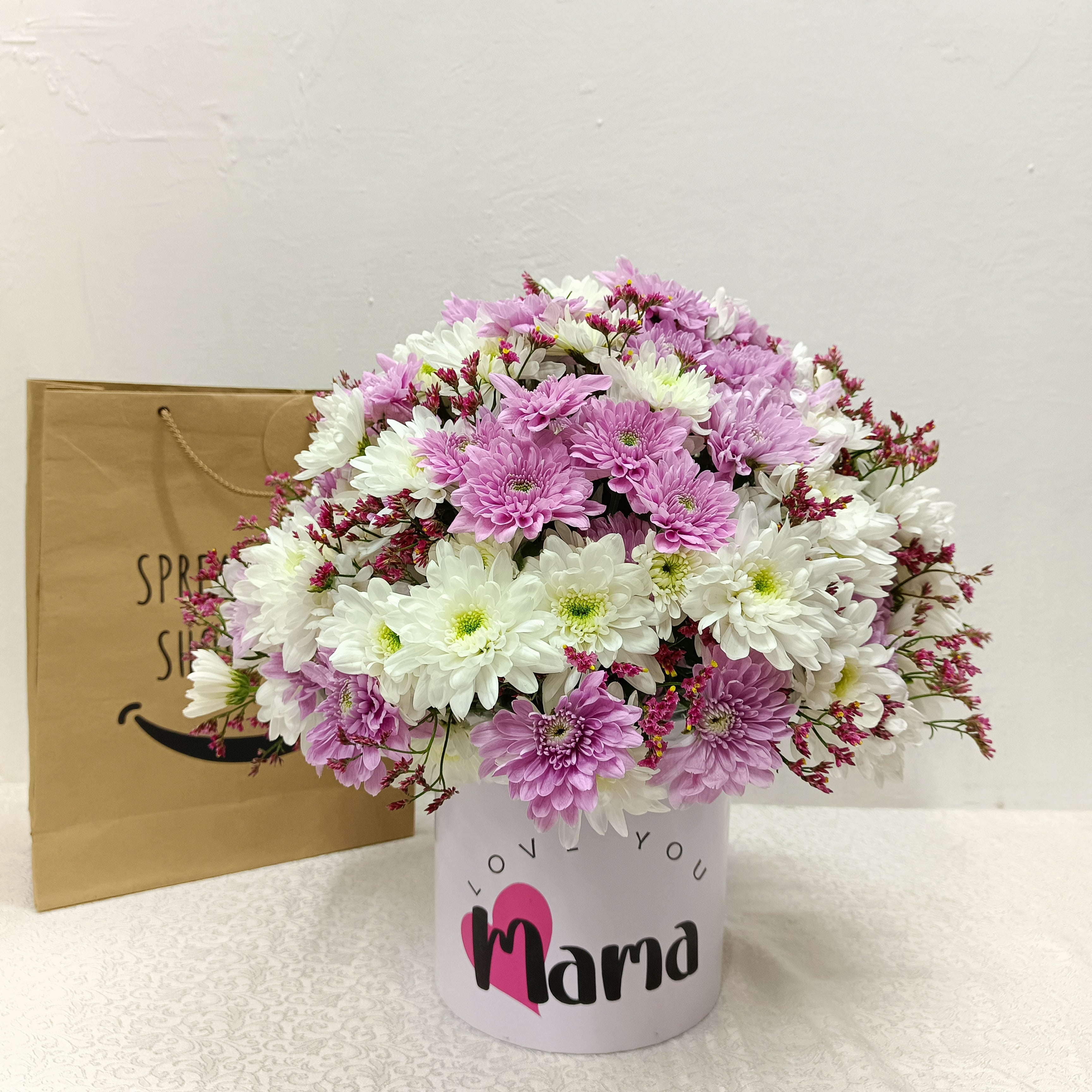 Mama's Round Surprise Flower Arrangement by Simona Flowers