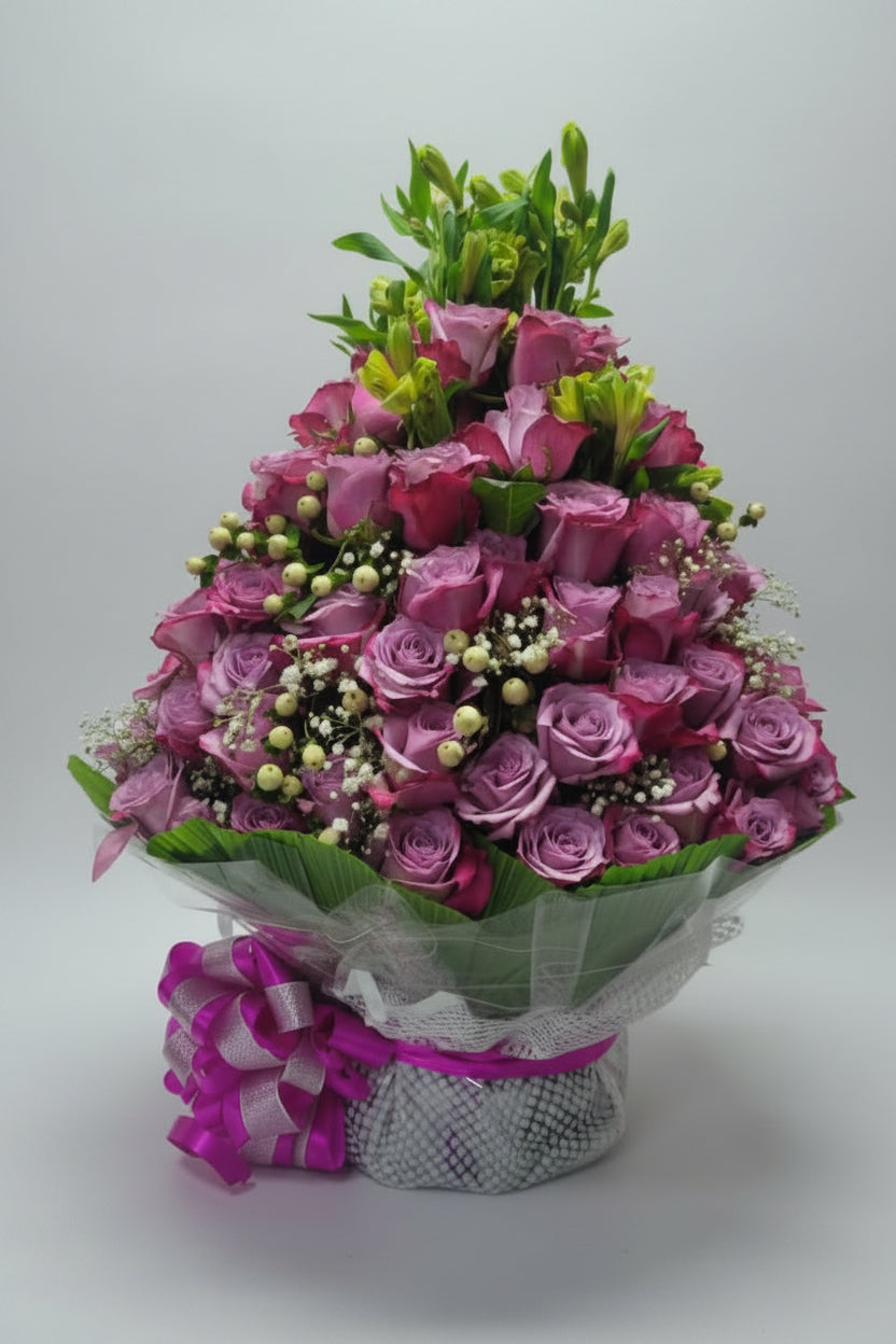 Bouquet of purple-shaded roses with greenery