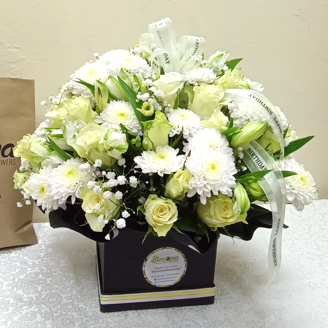 The Blossoms Ripple bouquet by Simona Flowers Kenya, is an assortment of white beauties consisting of: White Roses White Chrysanthemums Baby's Breathe & White Seasonal Flower Fillers