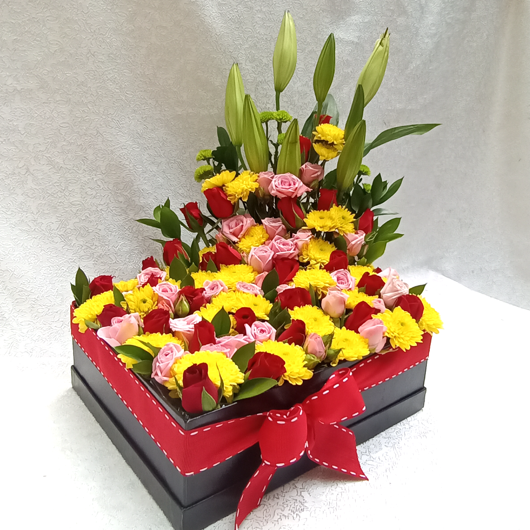 Simona Flowers - A wonderful garden box arrangement design with a bright-colored theme of roses and mums. The Lilies are used as a background view that later open up to share a wonderful scent.