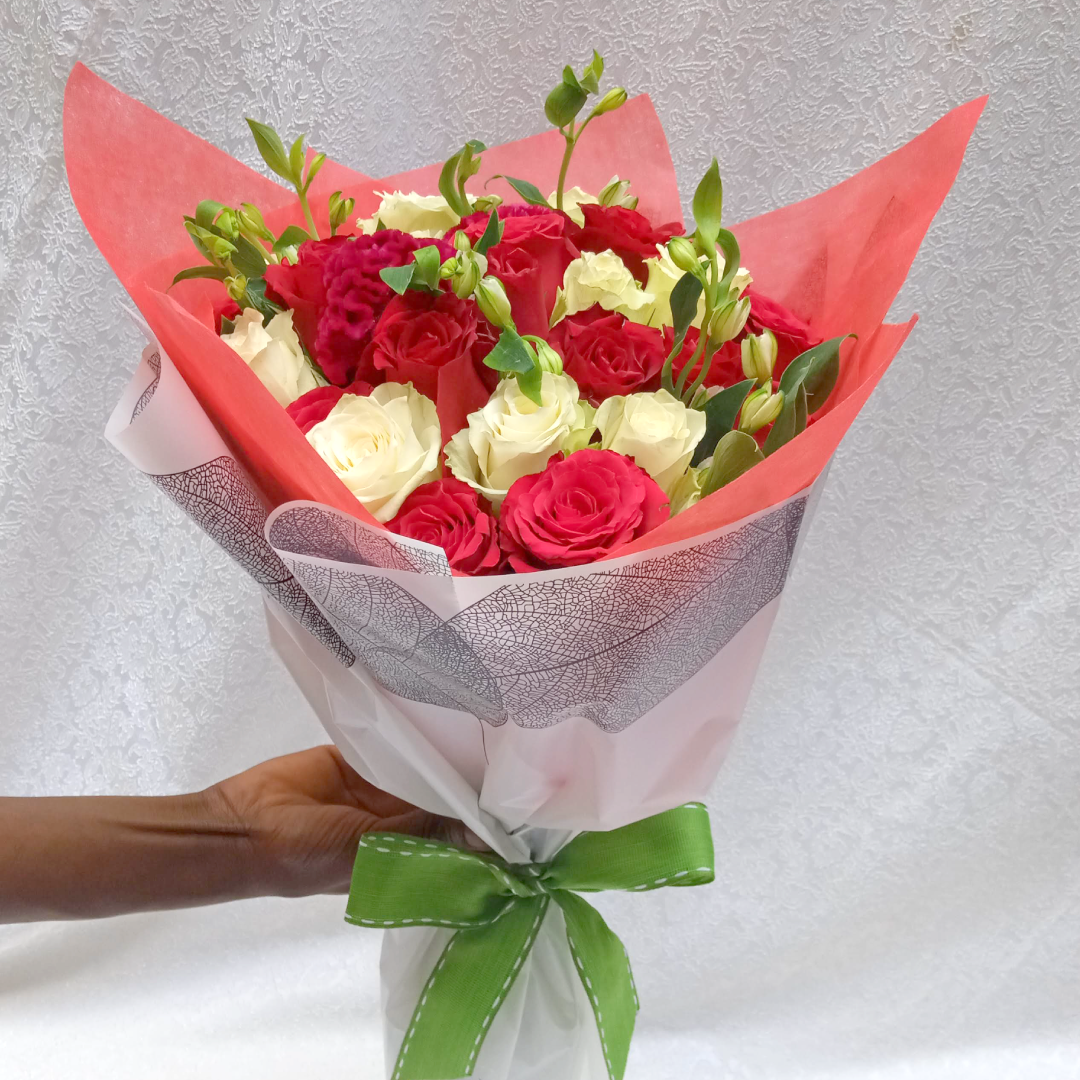 Cherry Bouquet by Simona Flowers Kenya, is a thoughtful floral arrangement prepared with: Red Roses White Roses and Seasonal flower fillers that have been put together to bring joy to both the giver and receiver of this amazing bouquet.