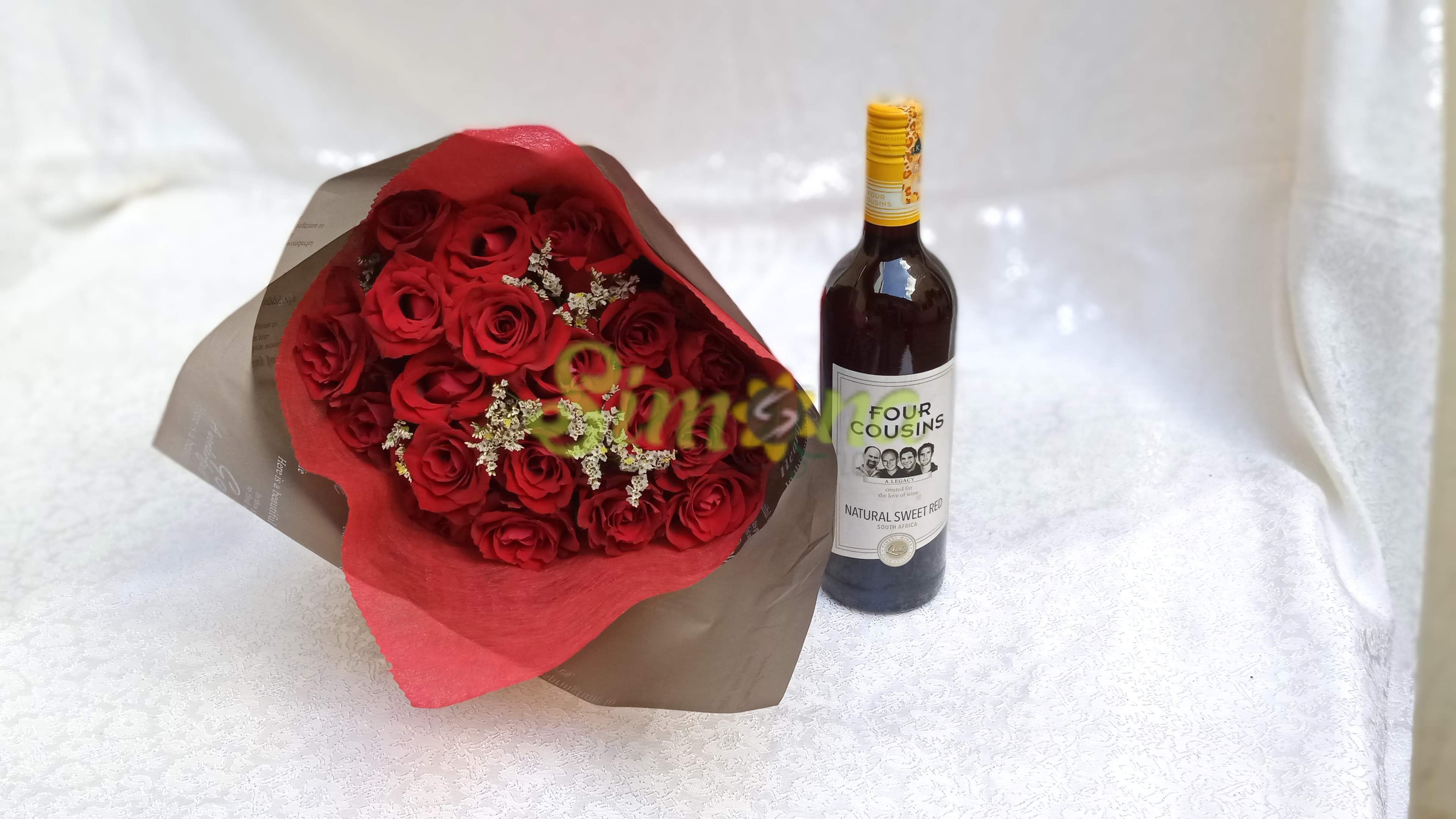 Delightful hand bouquet with red wine