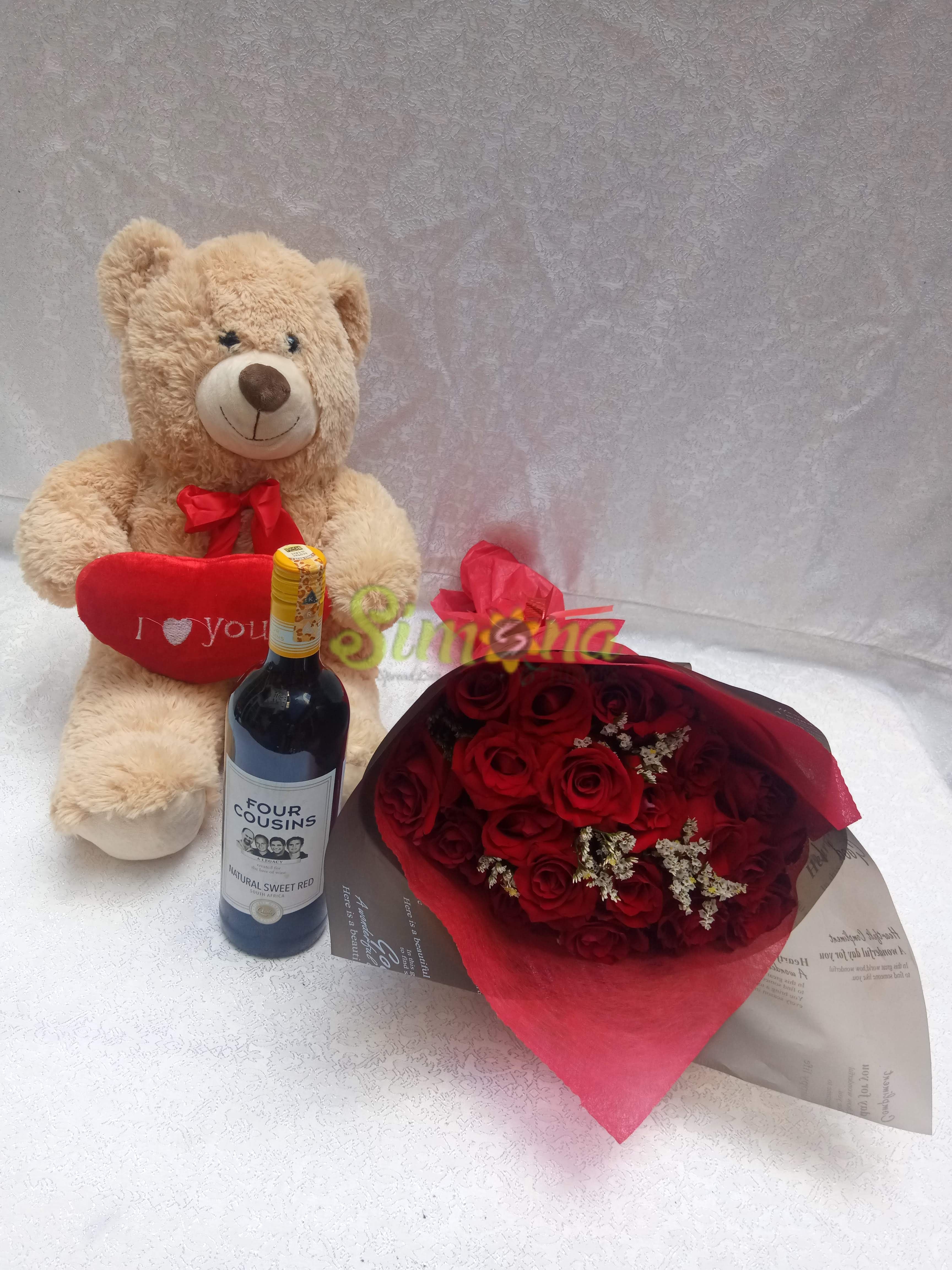 Delightful hand bouquet with teddy bear, red wine and hamlet chocolate