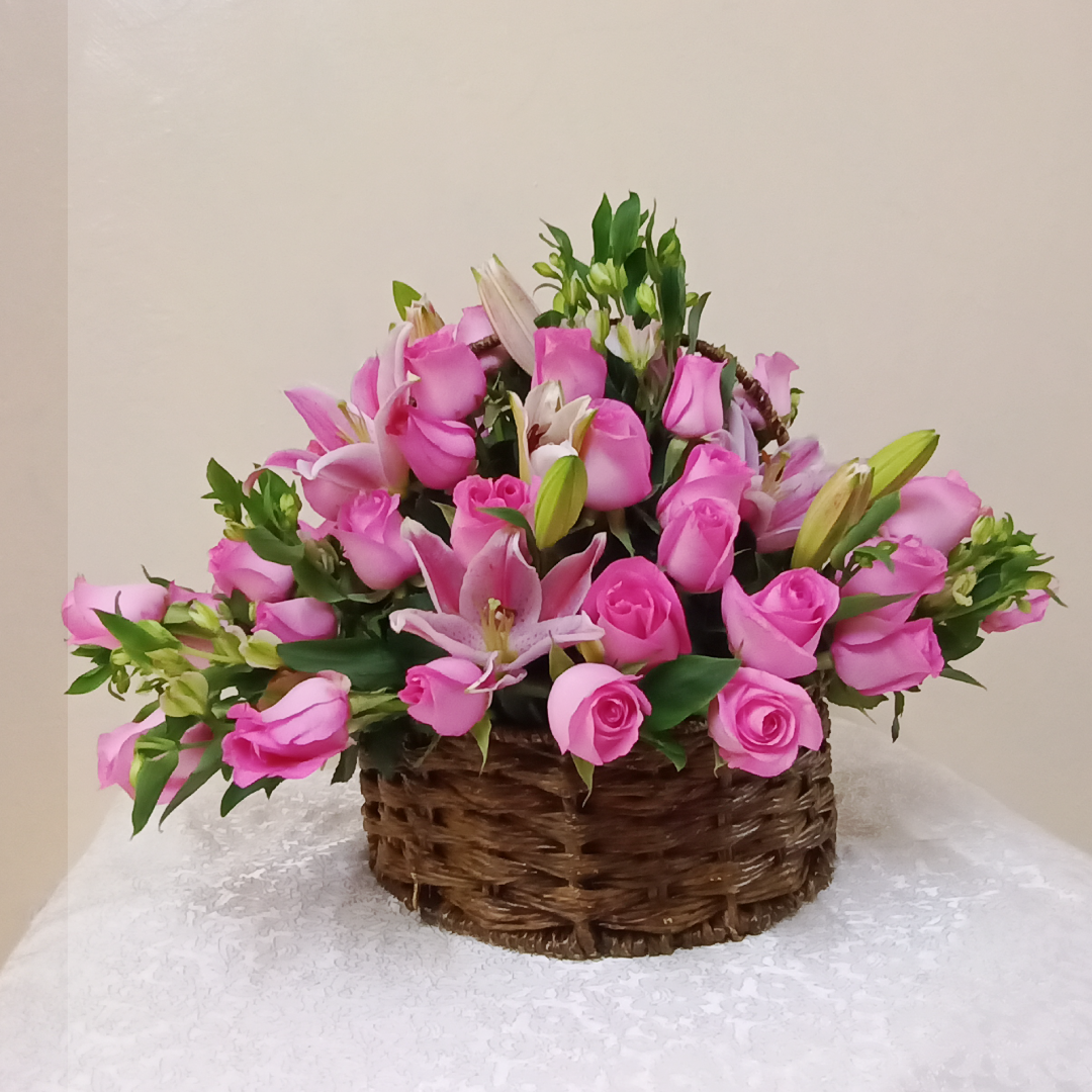 The Deluxe Flower Basket by Simona Flowers Kenya, An arrangement of assorted flowers in a round basket prepared with: Pink Roses Alstroemeria Various Seasonal flower fillers