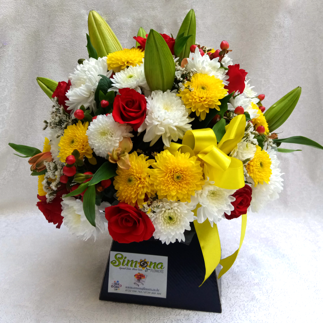 Simona Flowers Kenya - Greet them on the door with the stunning Love Pup Bouquet that is assorted with: Lilies Red Roses Yellow Chrysanthemums Hypericum Flowers White Chrysanthemums Seasonal Flower Fillers