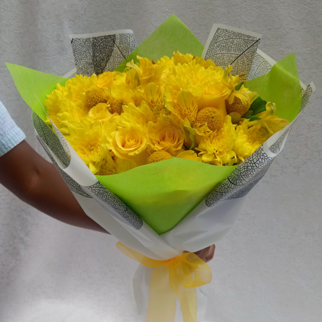 The Sunrays Burst Bouquet by Simona Flowers Kenya, is a vibrant floral arrangement meant to uplift spirits of joy and happiness in a loved one. Easily giftable to persons of all ages and both genders.
