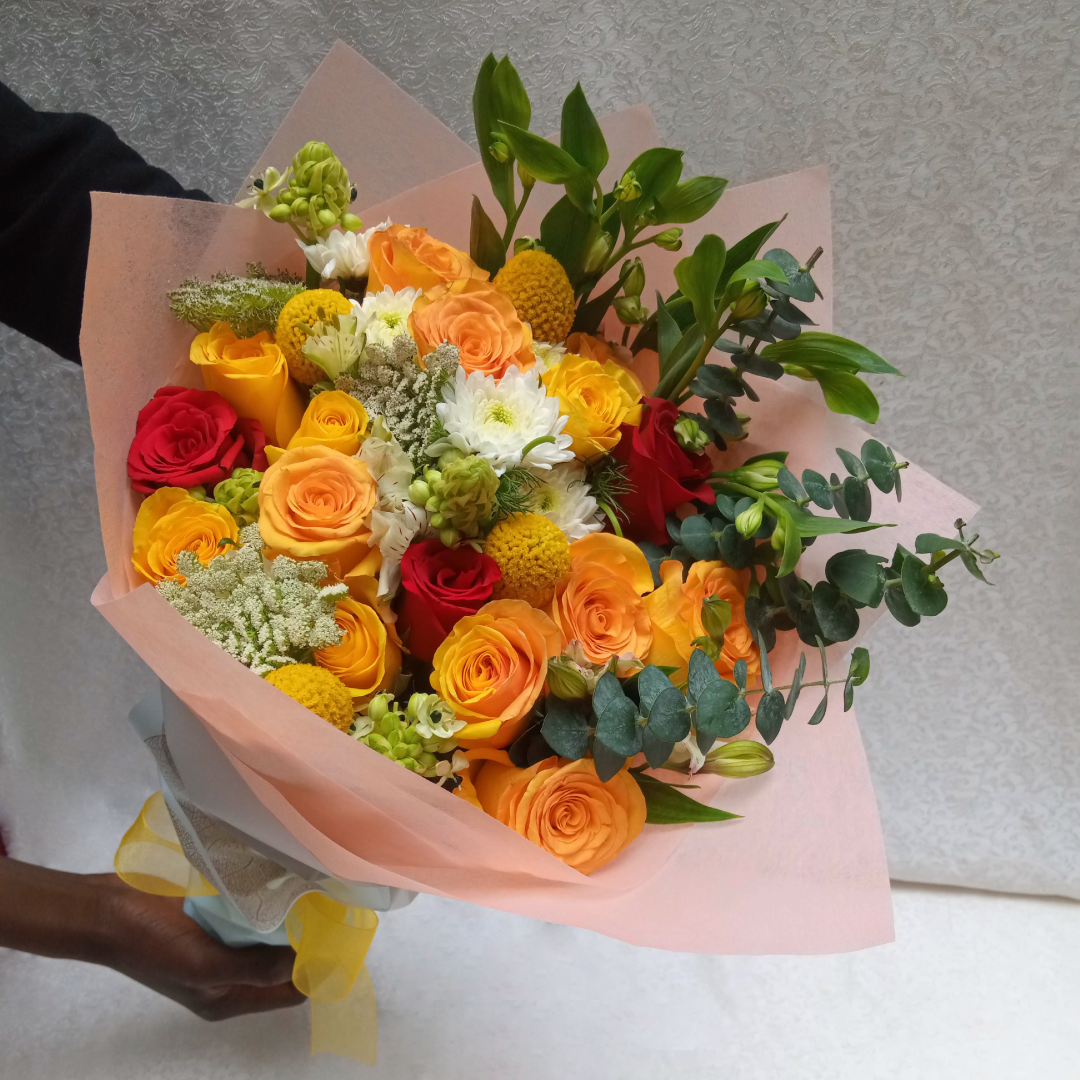 Simona Flowers Kenya - Get a  wonderful and romantic hand bouquet to express your love sentiments perfectly with The Touch Of Roses Bouquet, which is prepared with:  Chrysanthemums, Yellow Roses Red Roses Seasonal Flower Fillers to compliment
