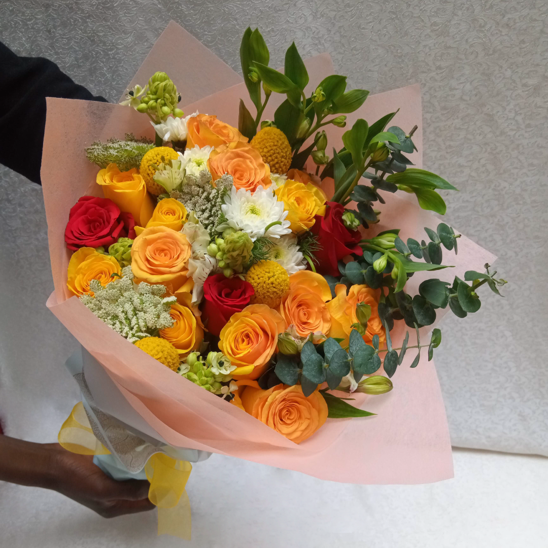 Simona Flowers Kenya - Get a wonderful and romantic hand bouquet to express your love sentiments perfectly with The Touch Of Roses Bouquet, which is prepared with: Chrysanthemums, Yellow Roses Red Roses Seasonal Flower Fillers to compliment