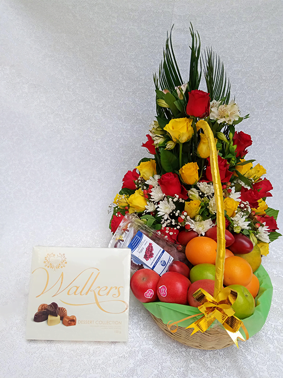 Flowers and fruits in a basket sided with a chocolate