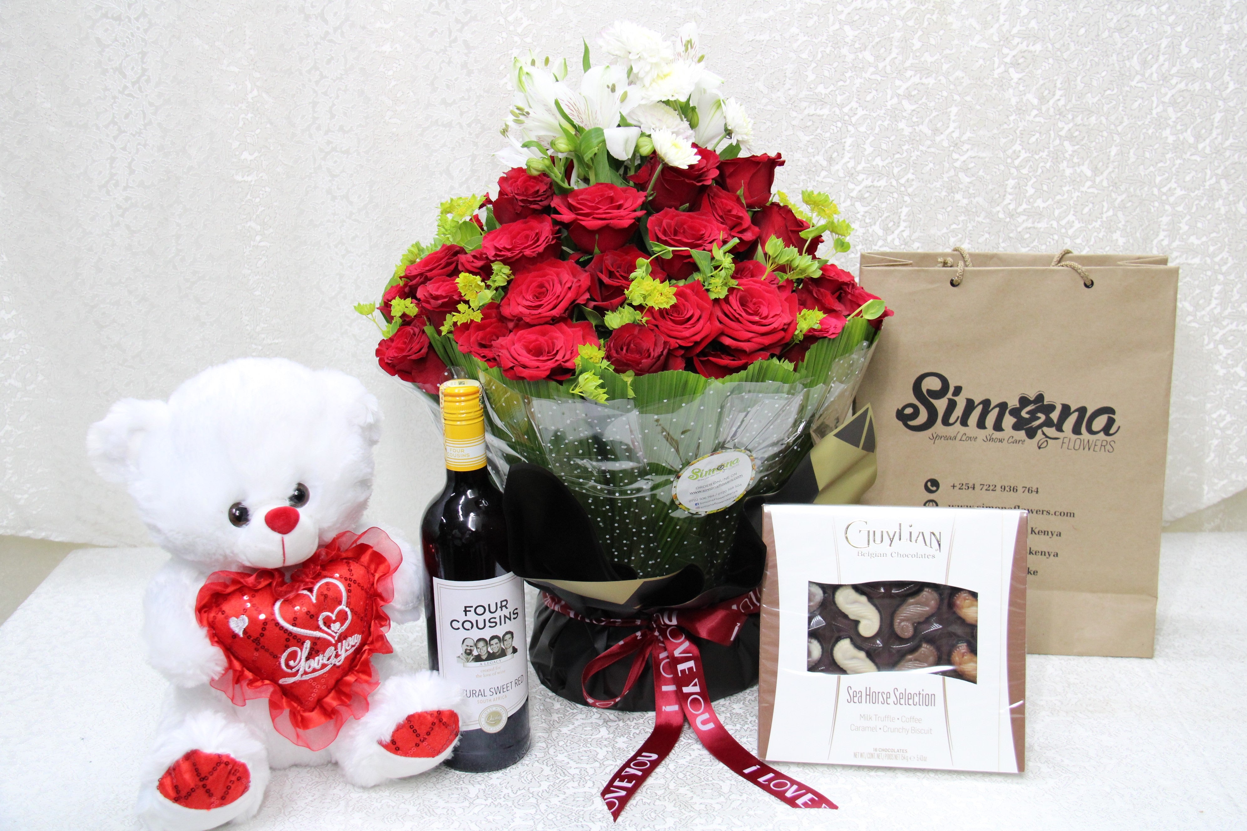 Simona Flowers - The package contains the cupid water bouquet, a box of chocolates, a bottle of wine and a nice fluffy teddy