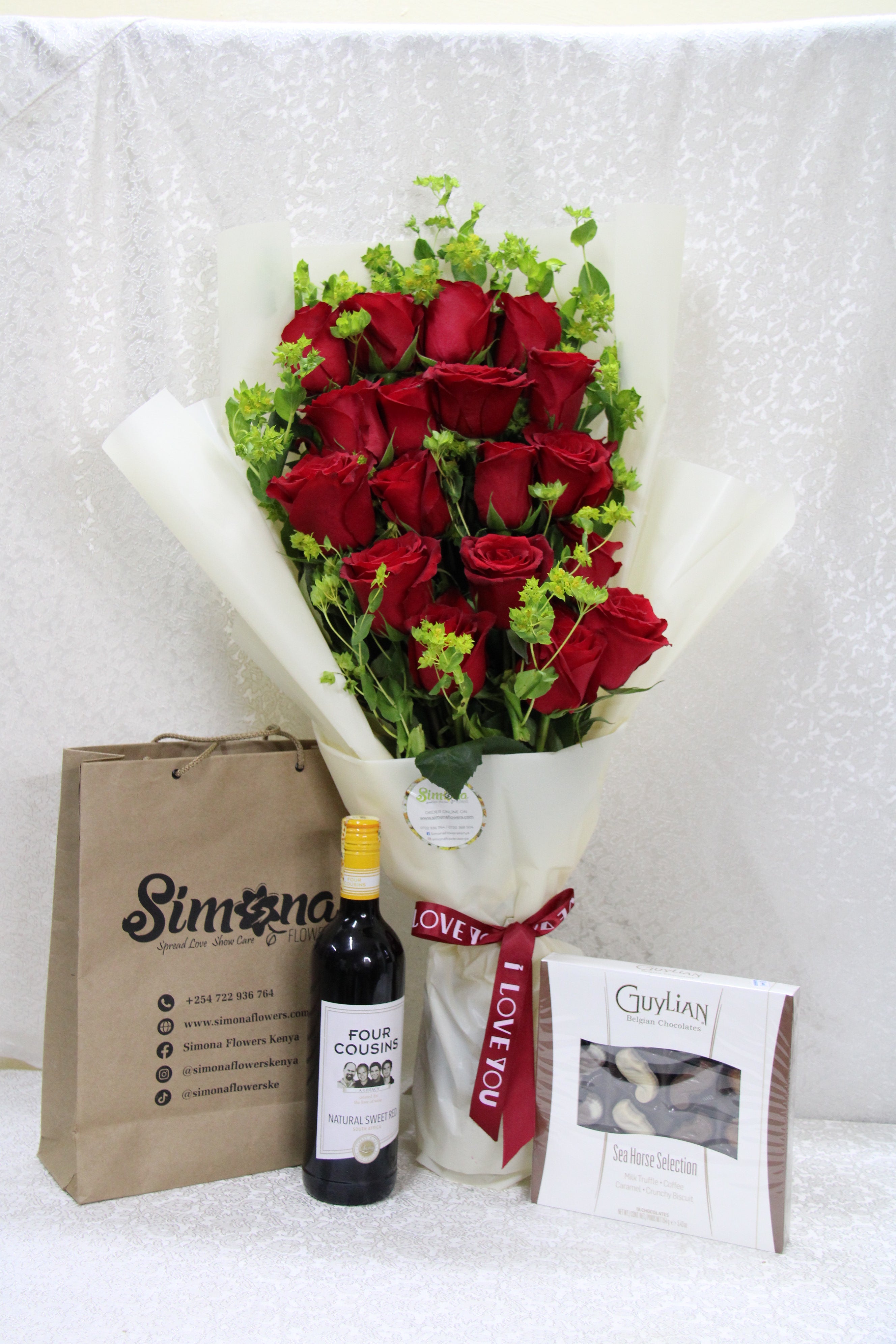 Adorable roses bouquet with wine and chocolate