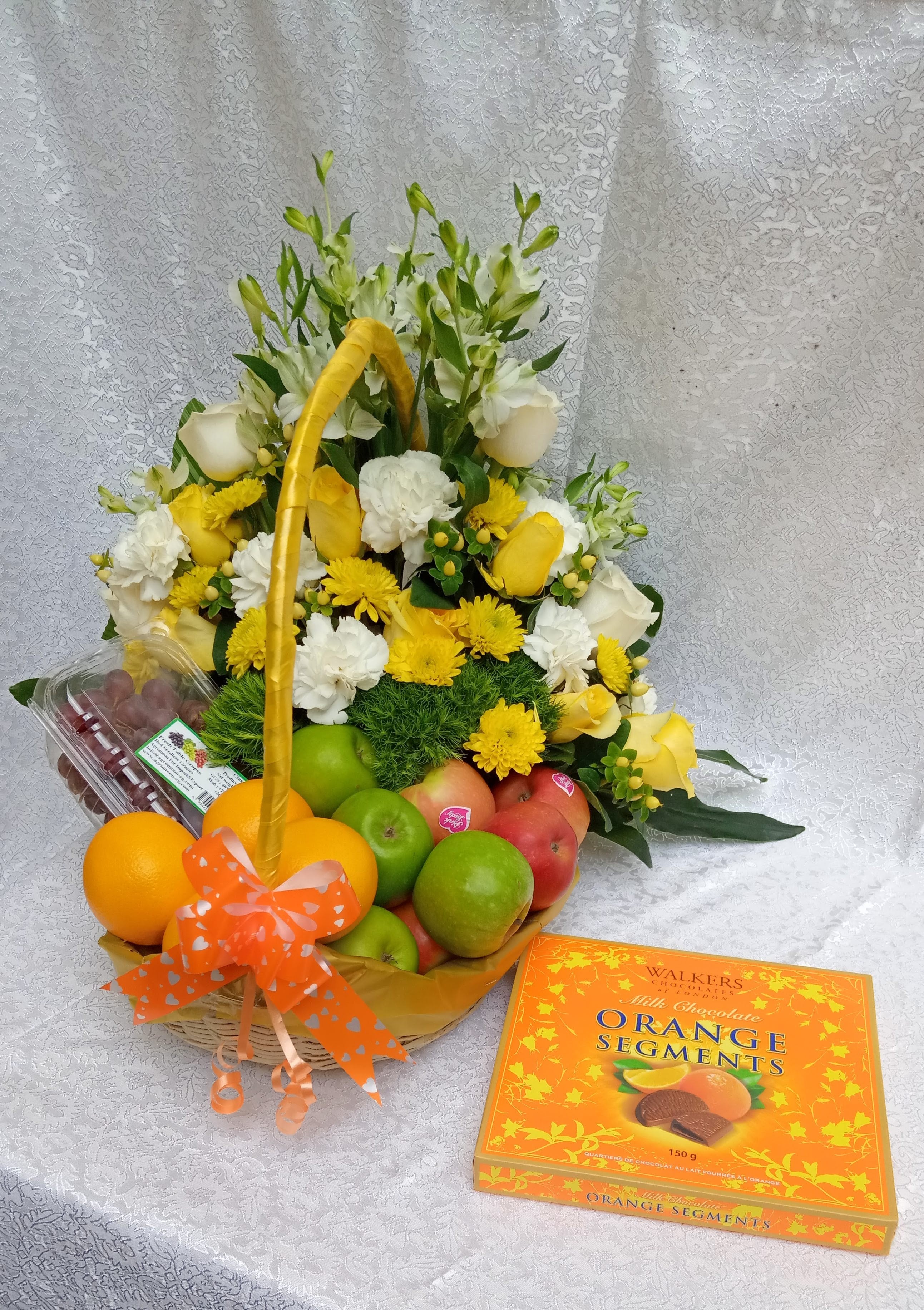 Fruits and flowers combo sided with a box of orange segment chocolates