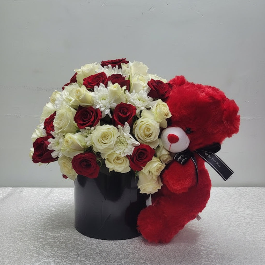 Bouquet of red and white flowers with a red teddy bear by Simona Flowers and Gifts.