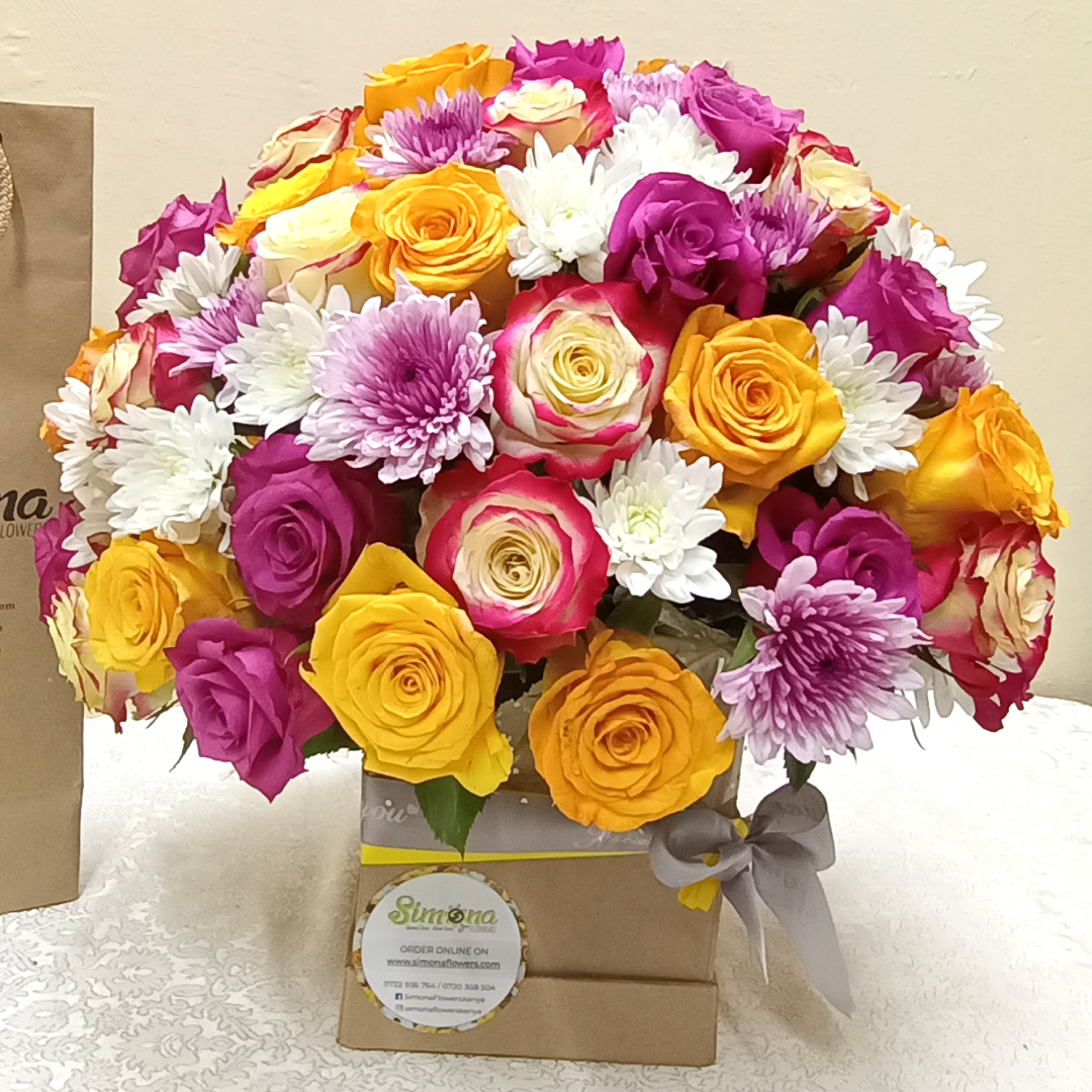 Simona Flowers Kenya - With Same day delivery, this Royal's Celebration birthday flower bouquet will make their day extra special and unforgettable.  The flowers arrangement include;  Yellow Roses Multicolored Roses Lilac/Lavender Roses Purple Chrysanthemums & White Chrysanthemums.