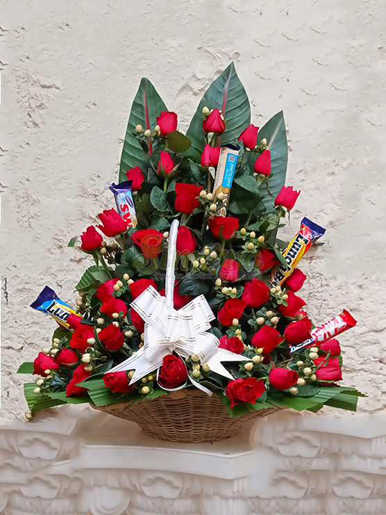 Scrumptious basket of red roses and chocolates by Simona Flowers