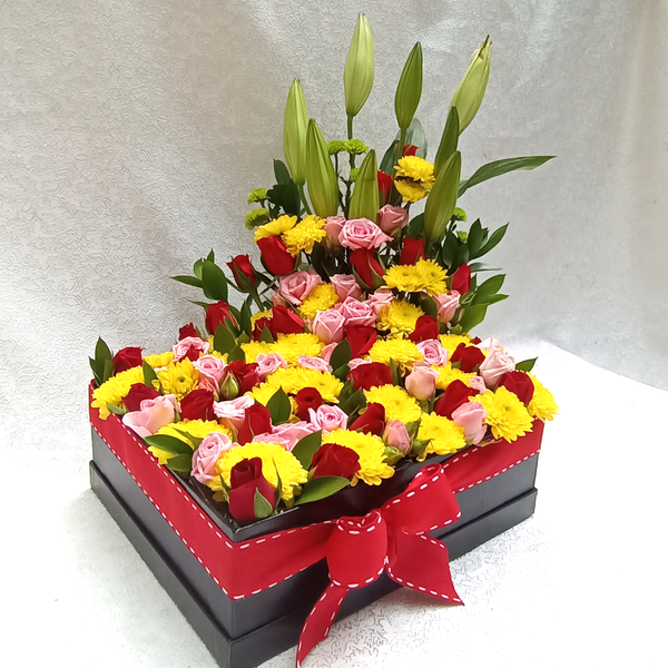 Simona Flowers  - A wonderful garden box arrangement design with a bright-colored theme of roses and mums. The Lilies are used as a background view that later open up to share a wonderful scent.
