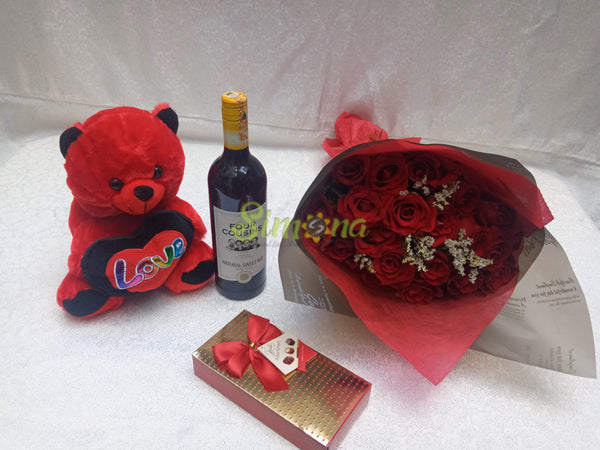 Delightful hand bouquet with red wine, teddy bear and hamlet chocolate