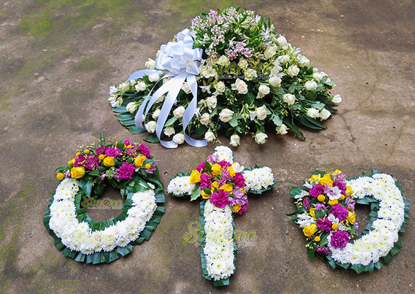 Devoted wreath set and casket spread flowers by Simona Flowers