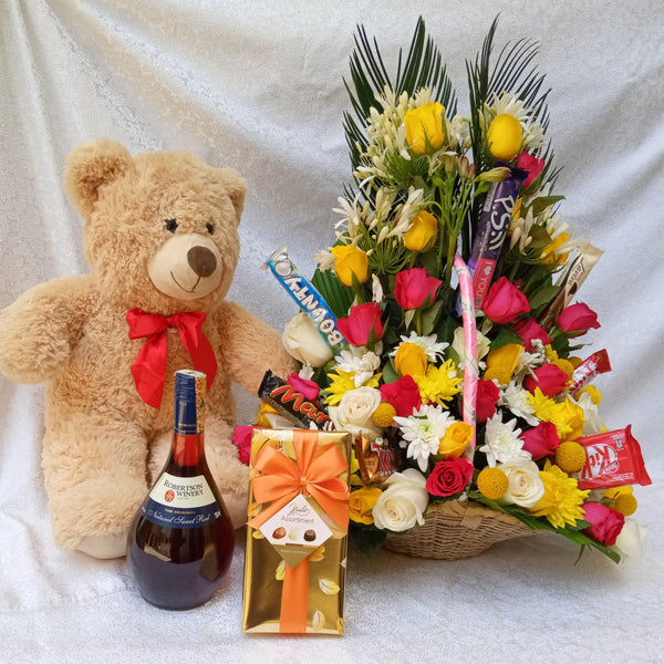 Simona Flowers - The Fleecy package comes as a combo package of the tropical flower basket with chocolates, a teddy bear, a bottle of wine, and a box of delicious chocolates.
