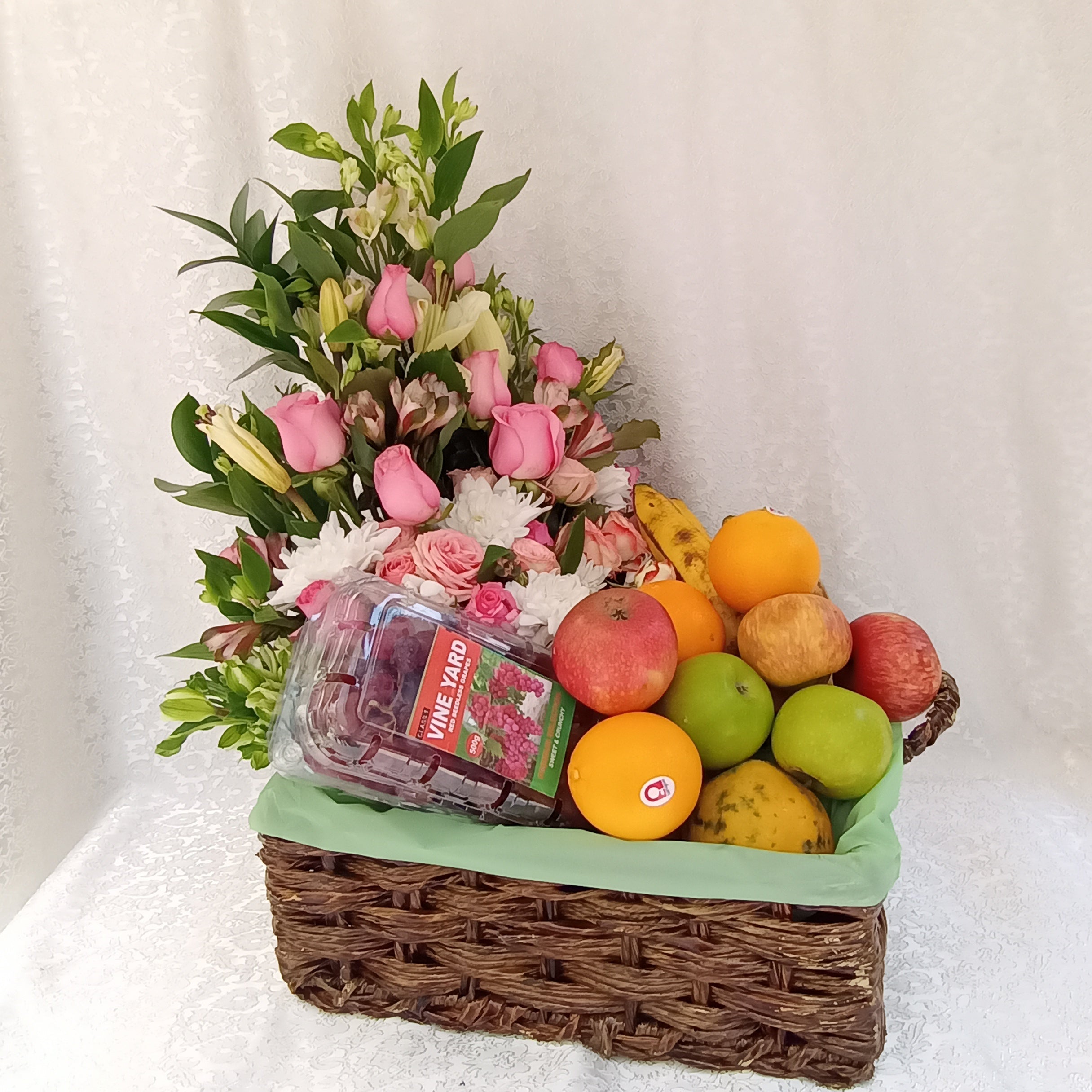 Juicy floral fruit basket of assorted fruits and flowers package