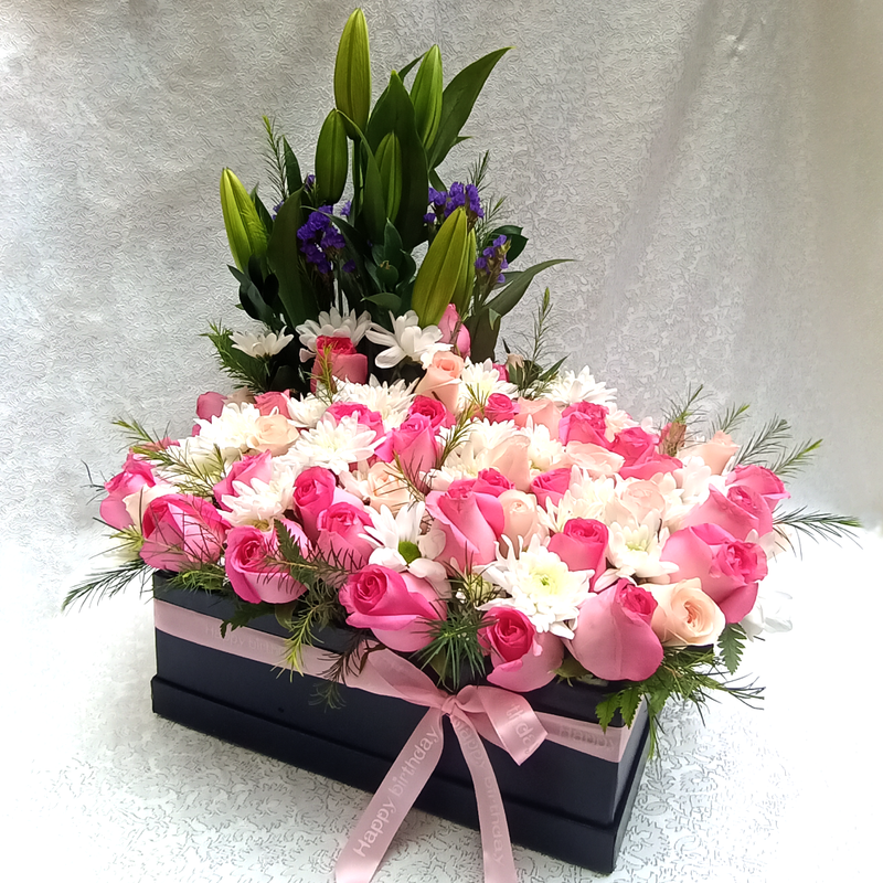 The Pink Garden Bouquet by Simona Flowers Kenya is A wonderful garden box arrangement design of a pink and white theme of roses and mums. The Lilies are used as a background view that later open up to share a wonderful scent.