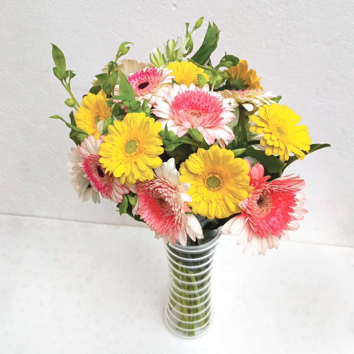 Sunshine Fantasy Vase Flower Arrangement by Simona Flowers Kenya. Prepared with vibrant Gaberas flowers perfect to put a smile on a friend's face and a loved ones face on any day.