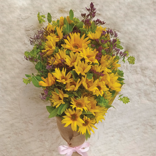 Sunflower Bouquet by Simona Flowers Kenya - Get the awesome sunflower bouquet and brighten up someone's day. It is brightly themed for a happy mood and wrapped with material for a classy finish. Have it delivered at home, work or even in the hospital on the same day.