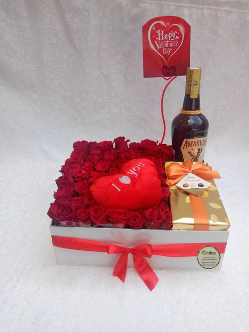 Simona Flowers Gifts - The Valentino package is a sweet surprise package for your valentine. With a creamy Amarula, arranged flowers, a box of sweet chocolates and an "I love you" heart pillow, you can be sure that it will be all smiles when they receive the romantic gift package.