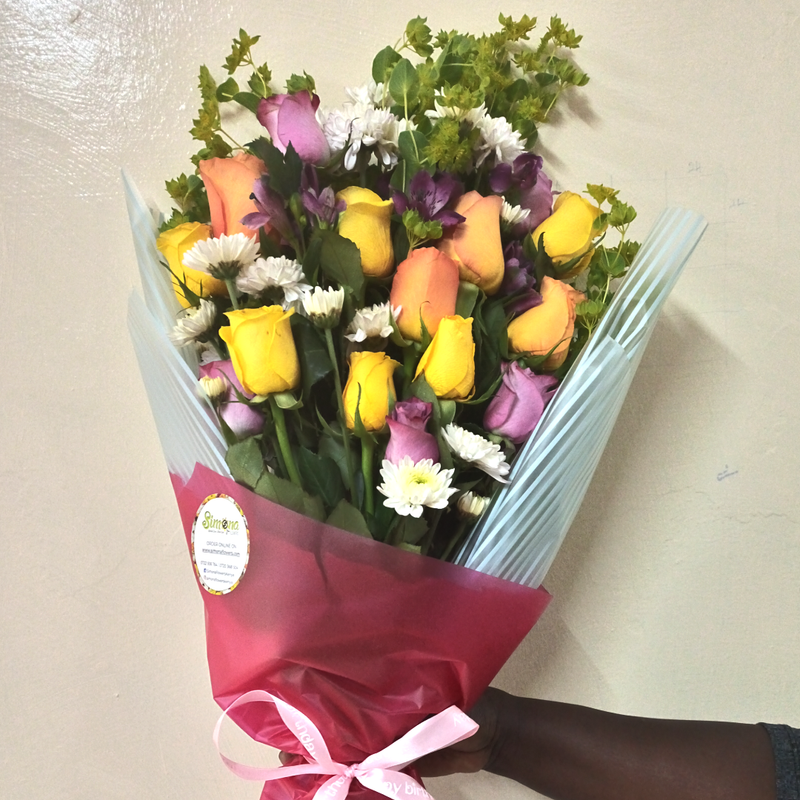 The Smile Recovery Bouquet by Simona Flowers Kenya, consists of; Yellow and Lavender Roses White Chrysanthemums With accompanying seasonal flower fillers