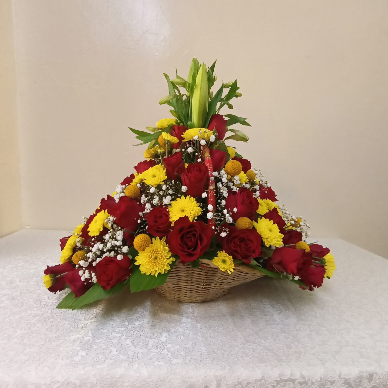 Simona Flowers - A red and yellow-themed flower basket of roses and mums, including flower fillers to make it pop even more. It's perfect as a gift that is given to show your love to someone.