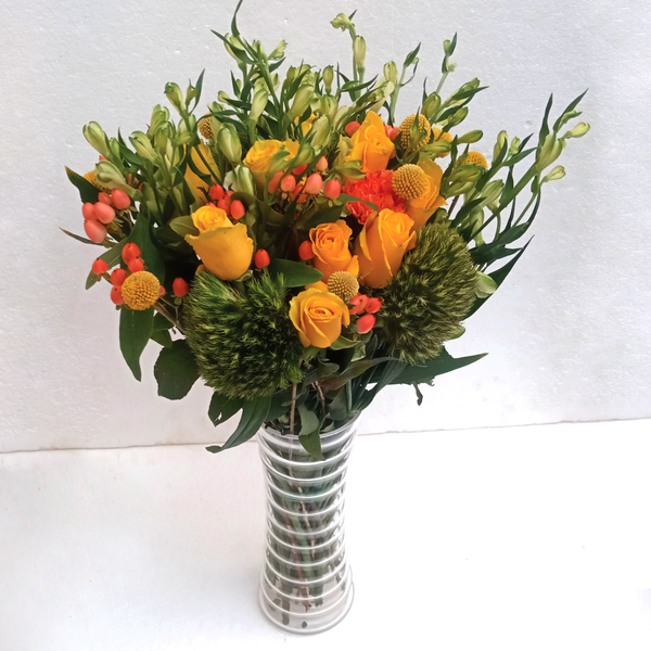 The Wild Perfection Vase Flowers Arrangement by Simona Flowers Kenya. Consists of tropical flowers and seasonal flower fillers in a clear stripped vase; perfect for uplifting a friends spirits when they are feeling down.