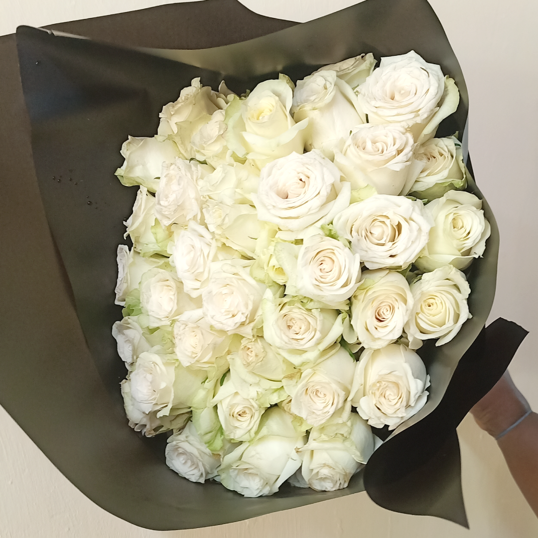 White Roses Blend Bouquet by Simona Flowers Kenya,is a monochromatic blend of roses ranging from pink to red to orange to yellow to lavender and white roses, with a finishing of white fillers wrapped with care to present with love to the special someone in your life.