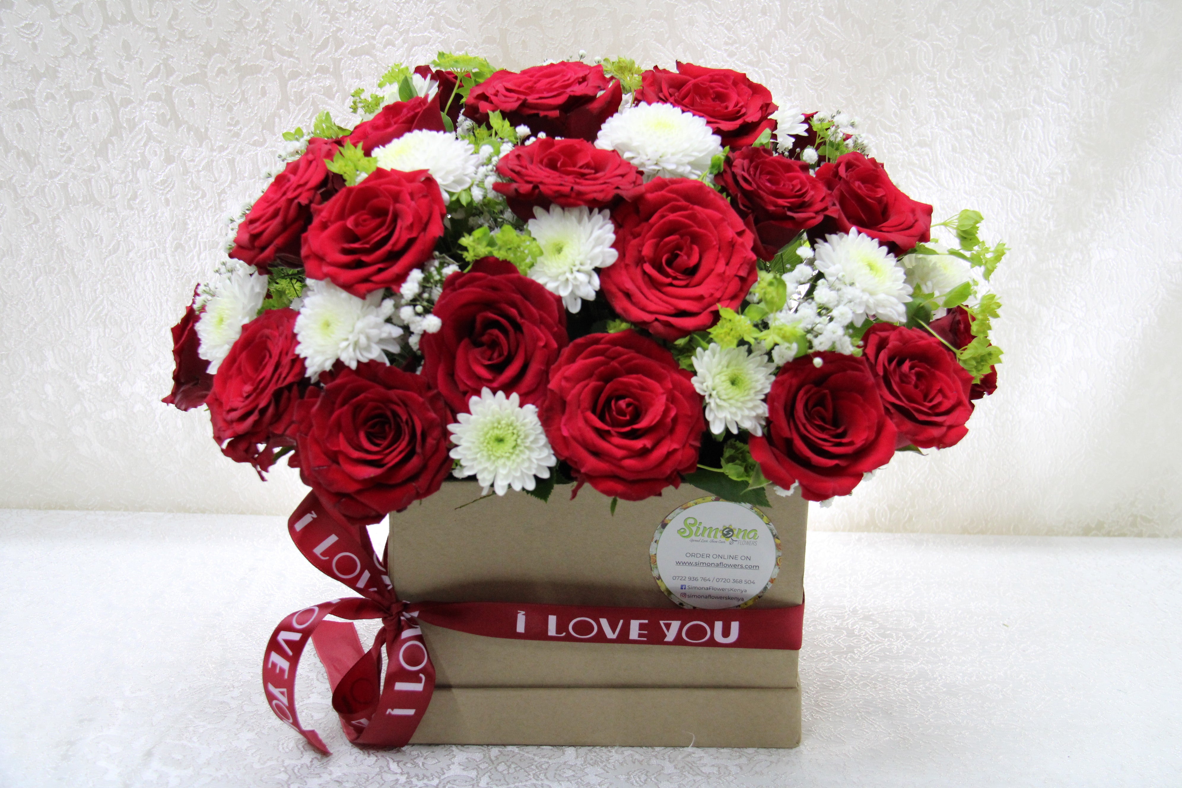Simona Flowers - An assortment of roses and complimenting flowers arranged in a royal box. The desire box is a nice touch of class to send to that special someone on valentines day.
