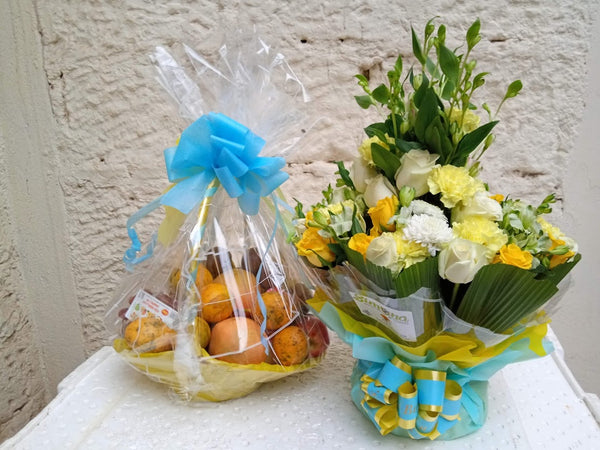 A package of an assorted fruit basket and flower arrangement