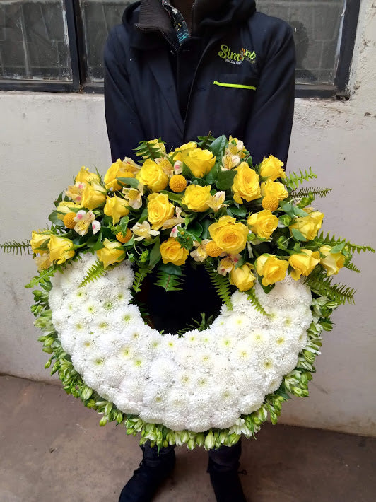 Executive glorious large round hand held funeral wreath by Simona Flowers