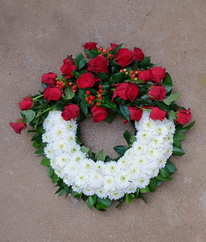 Executive ruby red rose round funeral wreath by Simona Flowers