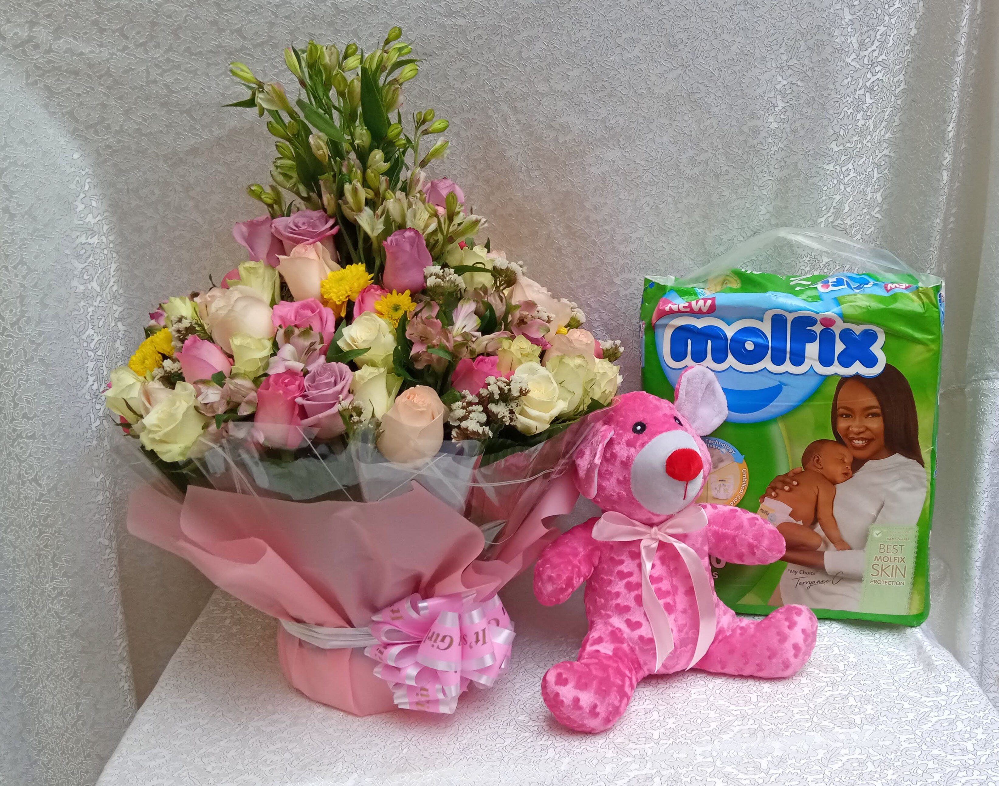 Water bouquet flower arrangement, teddy bear and diapers