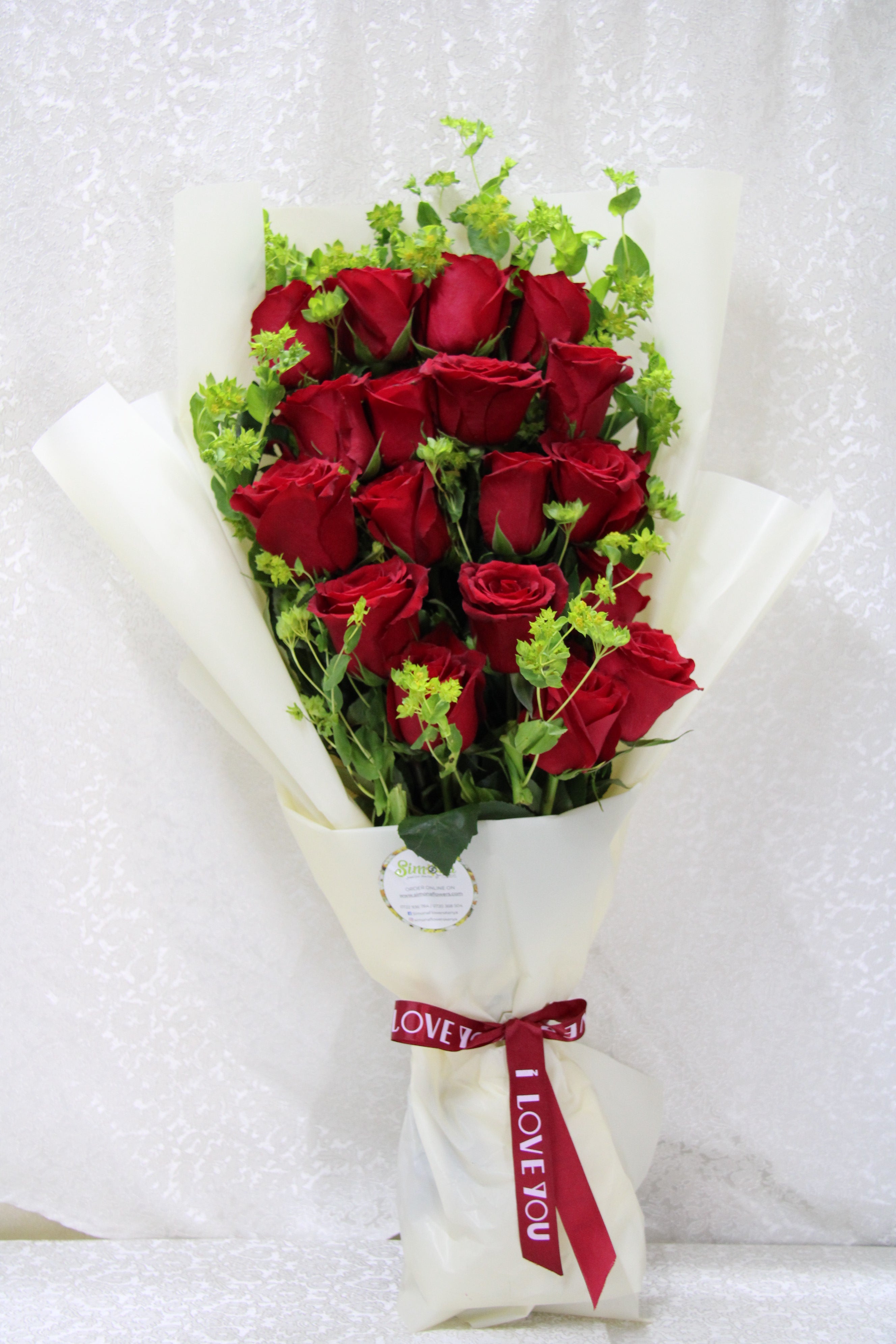 Simona Flowers - The adorable roses bouquet is a flat bouquet design of red roses wrapped with colours to compliment the day of passion this 14th of February.