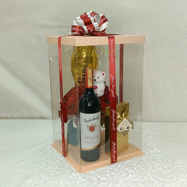 The passion package of mug flowers, wine, chocolate, a small teddy an balloon in a clear packaging 