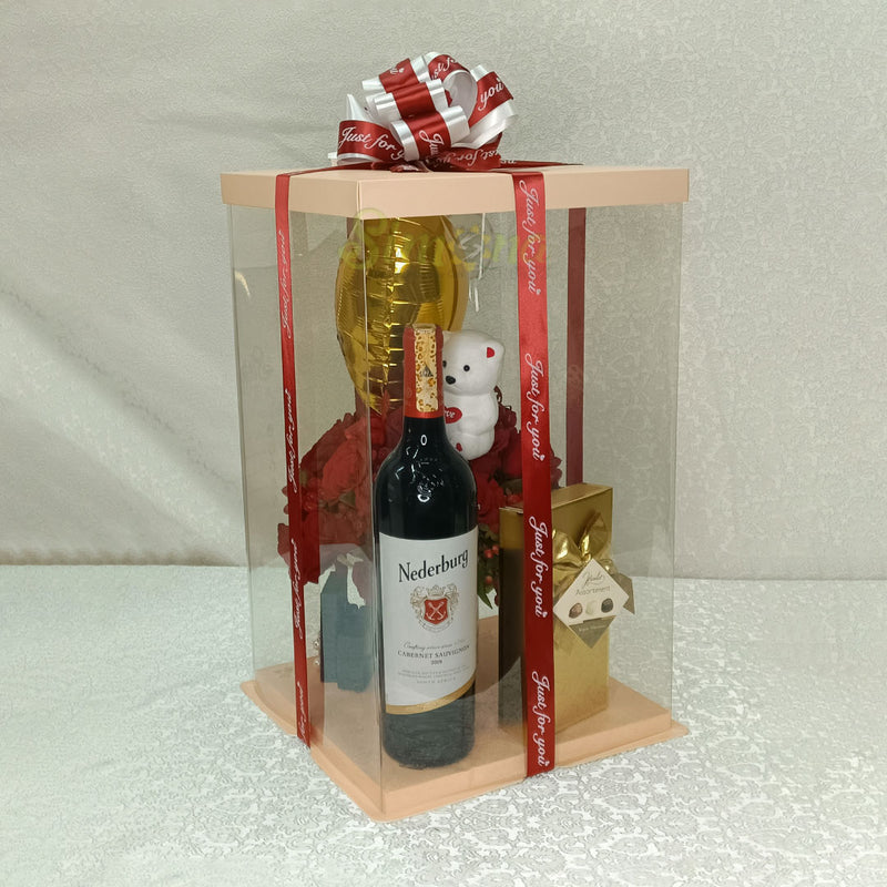 The passion package of mug flowers, wine, chocolate, a small teddy an balloon in a clear packaging 