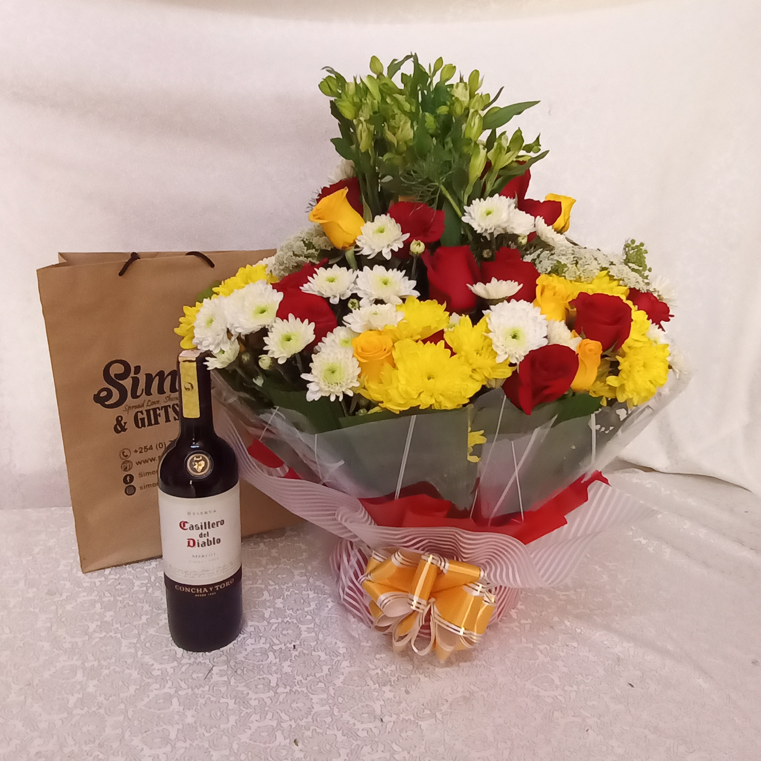 Simona Flowers - A combo consisting of a bouquet of assorted flowers and a bottle of red wine. The thoughtful package can be used to send good vibes from telling them I love you, or just missing you.